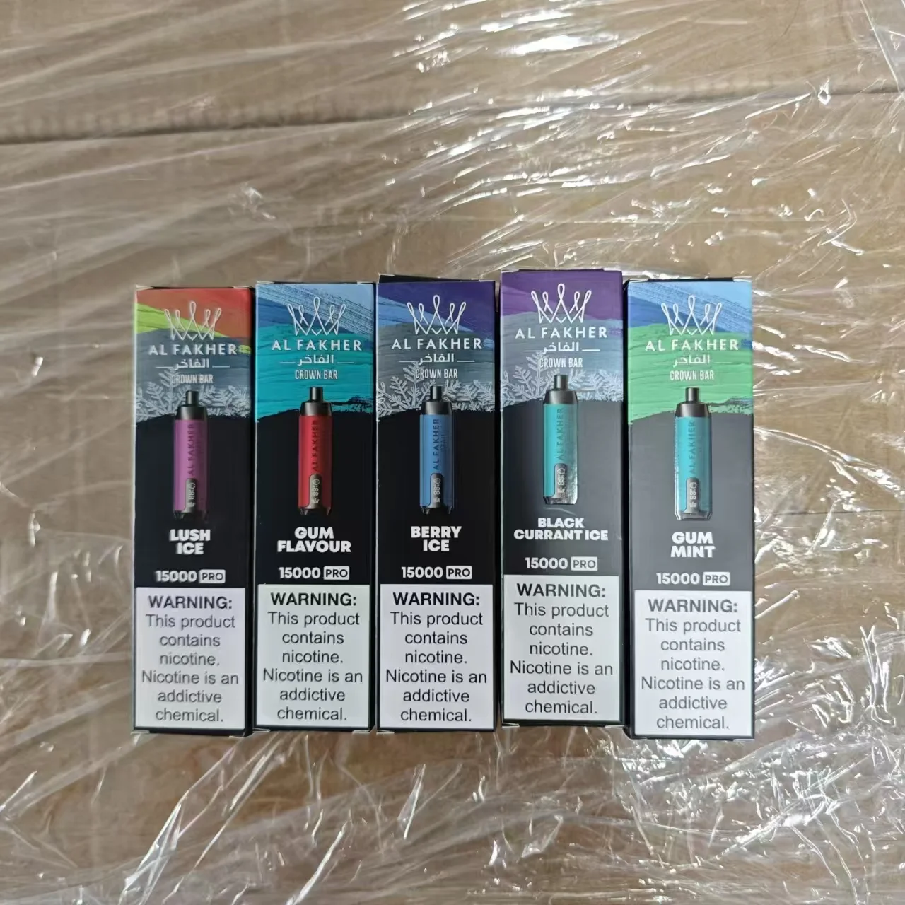 Five Al Fakher Crown Bar disposable vapes in various flavors including lush ice, gum flavor, berry ice, black currant ice, and gum mint.