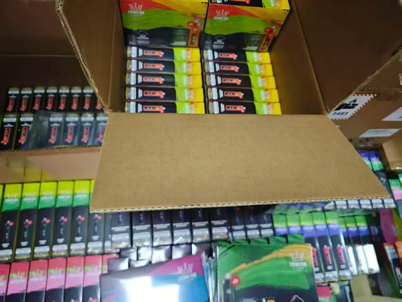 Boxes of ELF BAR and GEEK BAR vapes in a warehouse