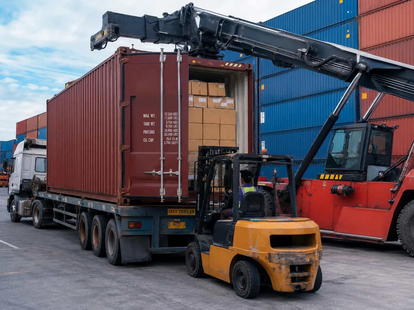 A shipping container being unloaded onto a truck