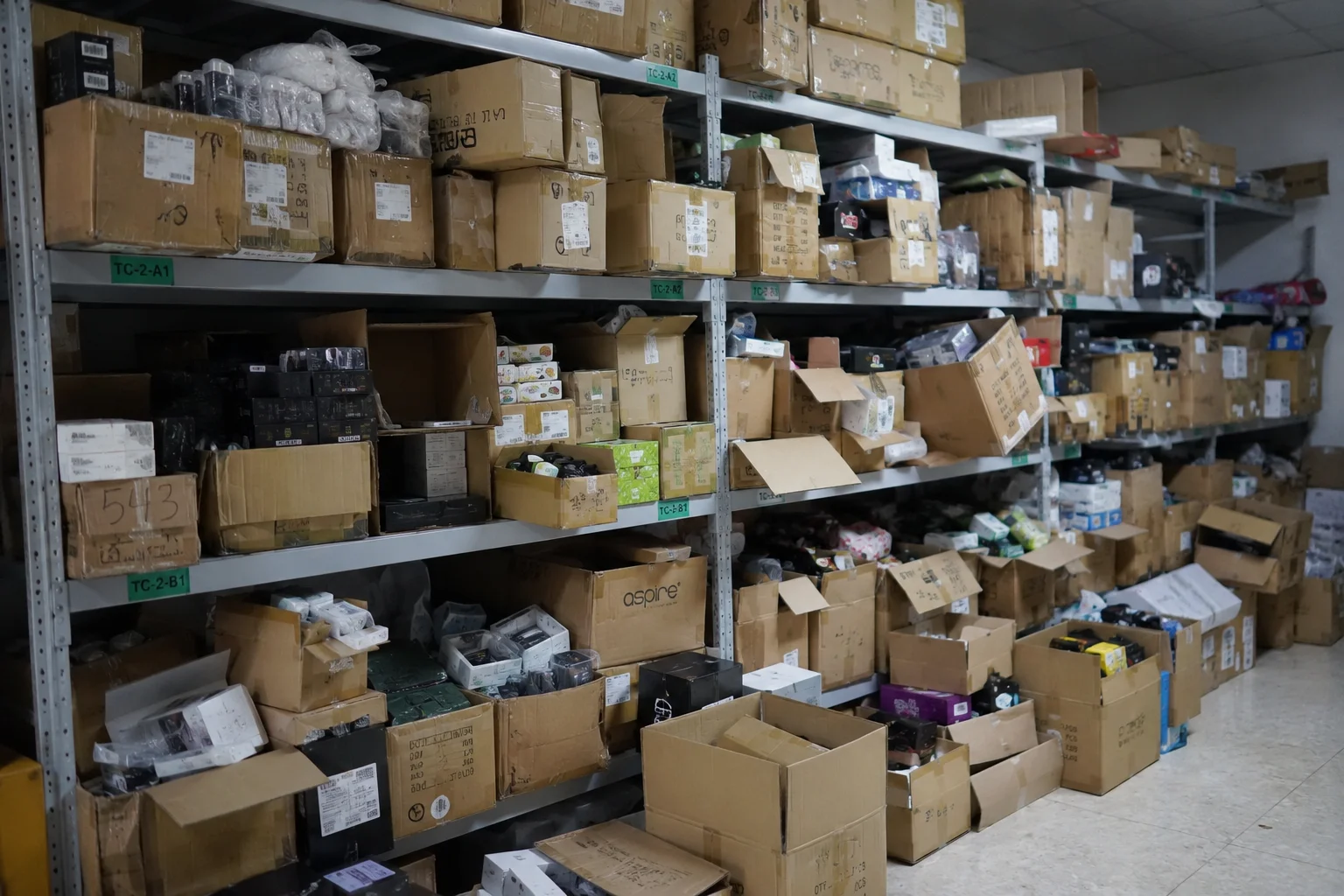 A warehouse shelf overflowing with disorganized boxes